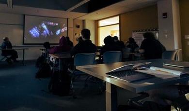 Students watch an episode of Star Wars in a classroom.